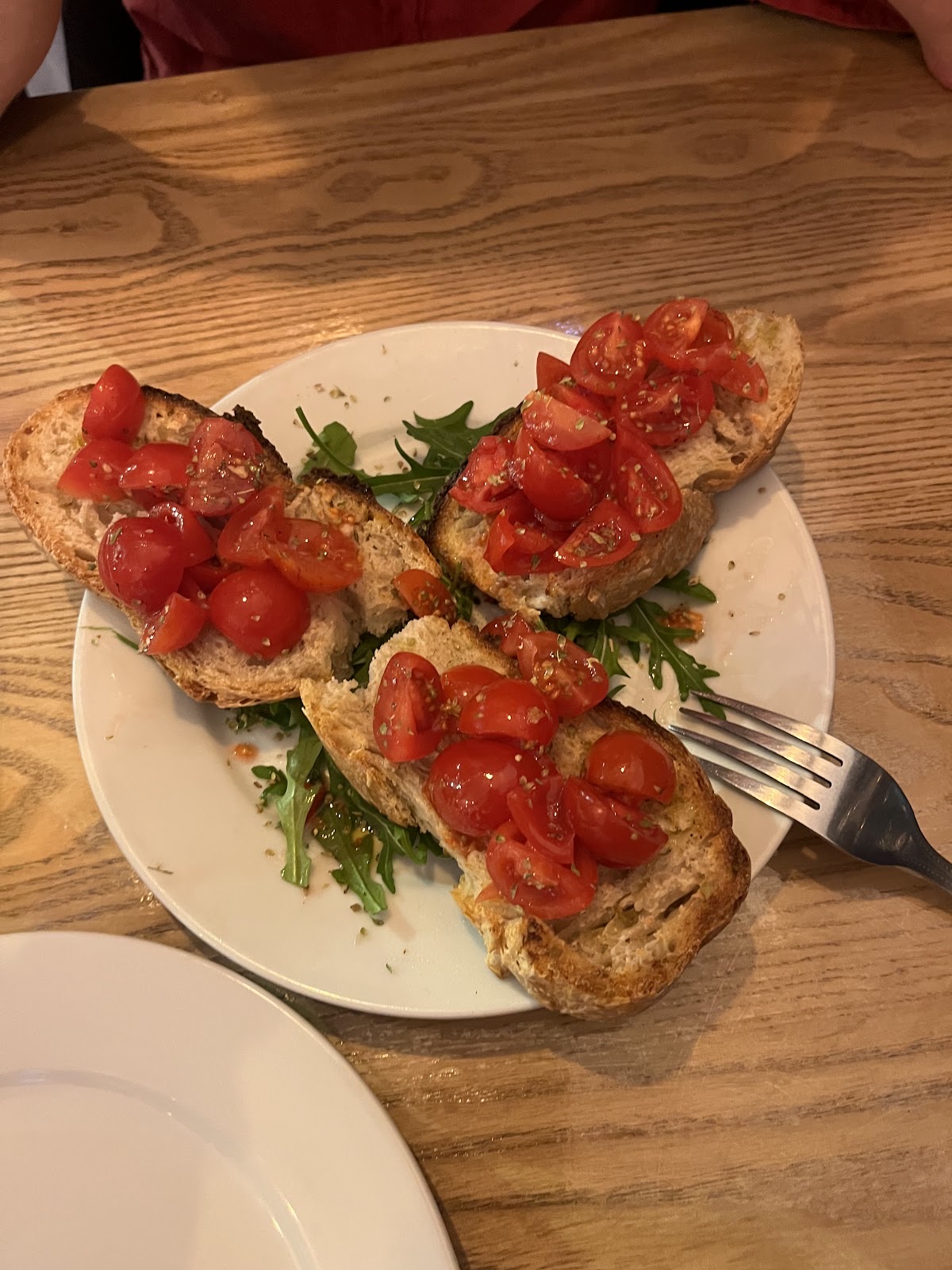 Bruschetta topped with chopped tomatoes and rocket